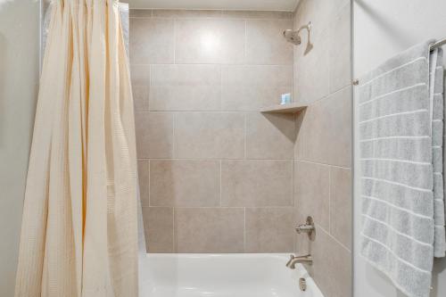 a bathroom with a shower with a shower curtain at 14 Mi to Dtwn OKC Quiet Yukon Gem in Yukon