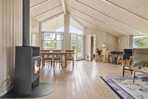 a living room with a fireplace and a dining room at 8157-Praesto-Svalevej-3 in Præstø