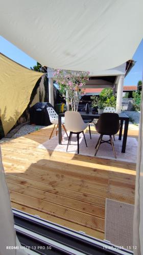 a patio with a table and chairs under a tent at Casa Nova in Njivice