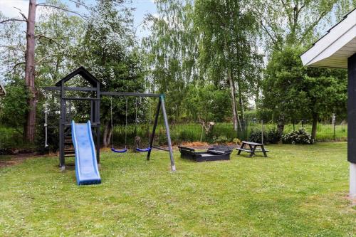 a playground with a slide and a swing set at 8157-Praesto-Svalevej-3 in Præstø