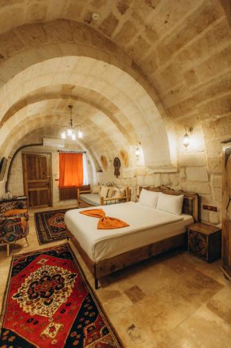 a bedroom with a large bed in a stone room at Timur inn Cappadocia in Goreme