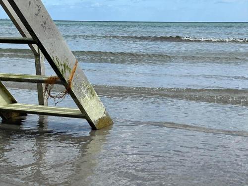 a stairway leading into the ocean on a beach at R744-Rodvig-Poppelager-7 in Rødvig