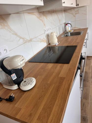 a kitchen with a coffee maker on a counter at Apartmány za kostelem in Husinec