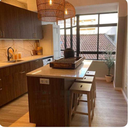 a kitchen with a island in the middle of a kitchen at Stay&view Santarém in Santarém