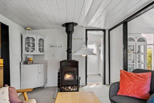 a living room with a wood stove in a room at 8223-Vordingborg-Laekrogen-13 in Vordingborg