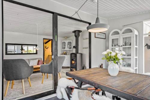 a living room with a wooden table and two dogs at 8223-Vordingborg-Laekrogen-13 in Vordingborg