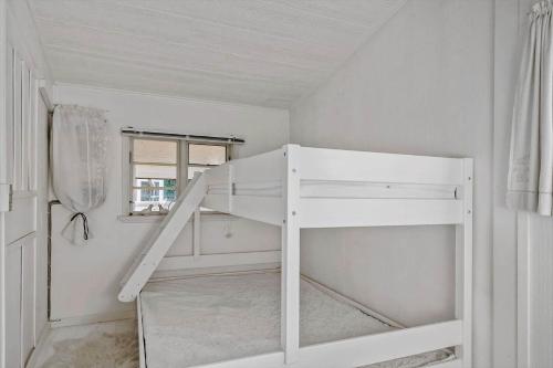 a white bunk bed in a white room at 8223-Vordingborg-Laekrogen-13 in Vordingborg