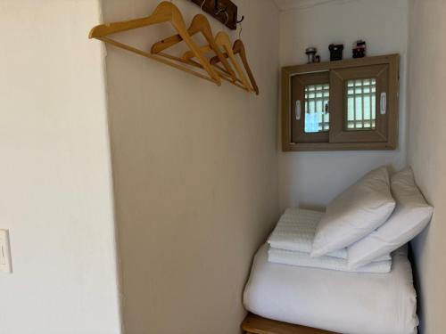 a room with two pillows and a shelf and a window at Pungnam House in Jeonju