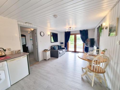 a kitchen and a living room with a table at Oak Lodge 10 Hot Tub in York
