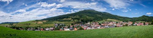 a small town on a hill in front of a mountain at Apartmány Ski Telgárt - Telgárt Resort in Telgárt