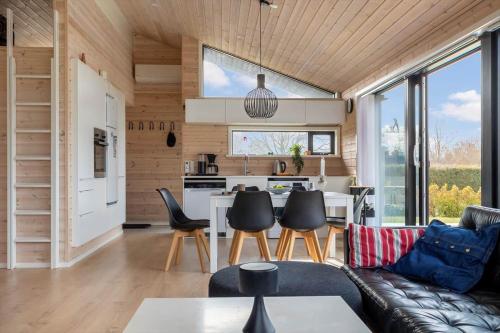 a living room with a couch and a table at S749-Stroby-Nattergalevej-9 in Strøby