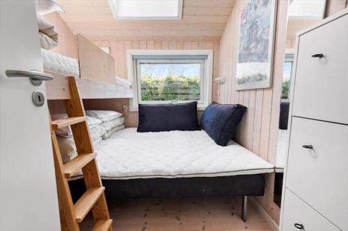a tiny house with a bed and a window at R956-Rodvig-Laerkevej-8 in Rødvig