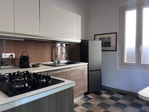a kitchen with a stove and a refrigerator at Casa Terragni 38 in Carpeneto