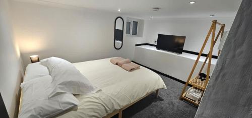 a bedroom with a bed and a flat screen tv at Refurbished 4-Bed Home Near Hospital & Station in Chatham