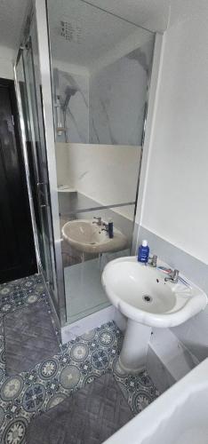 a bathroom with a sink and a shower and a toilet at Refurbished 4-Bed Home Near Hospital & Station in Chatham