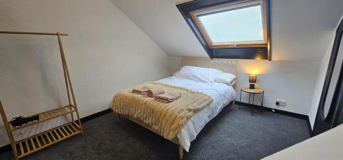 a small bedroom with a bed and a window at Refurbished 4-Bed Home Near Hospital & Station in Chatham