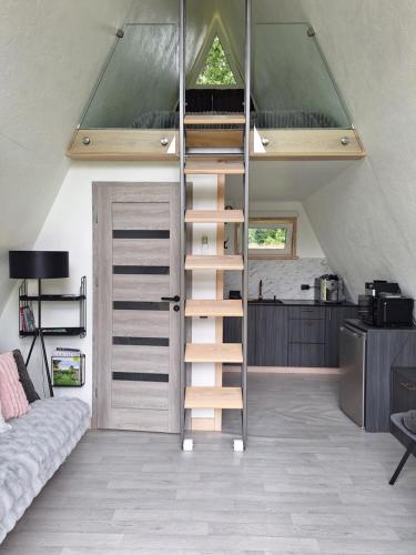 a loft bed in a room with a staircase at Rose Valley Cottage in Ieriķi