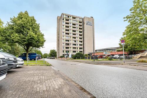 an empty street in front of a large building at Ferienwohnung 'Segelyachten-Perle' in Strande
