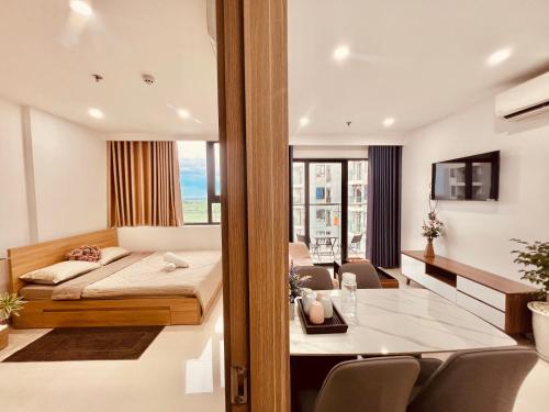 a bedroom with a bed and a dining room at NhiNhi Homestay in Thôn Văn Dương