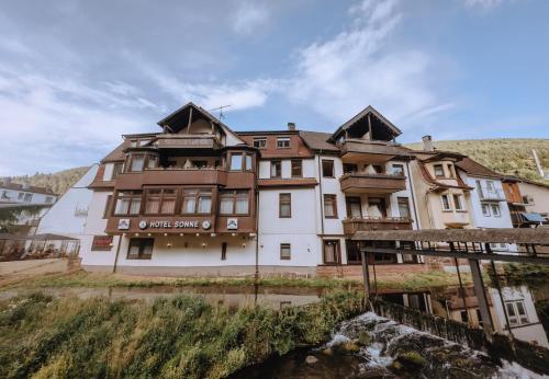 a building on the side of a river at Vinami-Sonne Hotel in Bad Wildbad