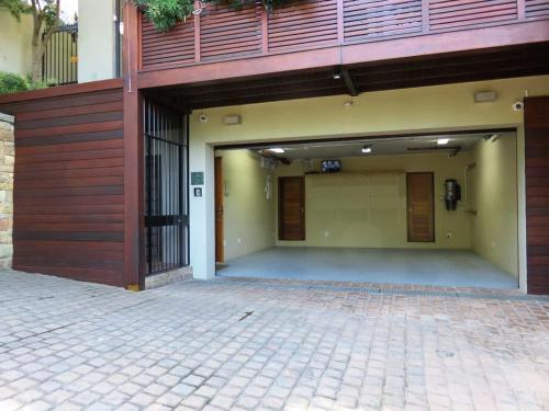 an empty parking lot with a building with a garage at Table Mountain Villa in Cape Town