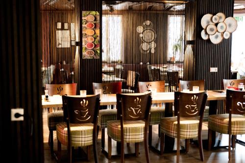 a dining room with a table and chairs at Vinami-Sonne Hotel in Bad Wildbad