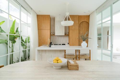 a kitchen with a bowl of fruit on a table at Nisí Villas Bingin, Uluwatu in Uluwatu