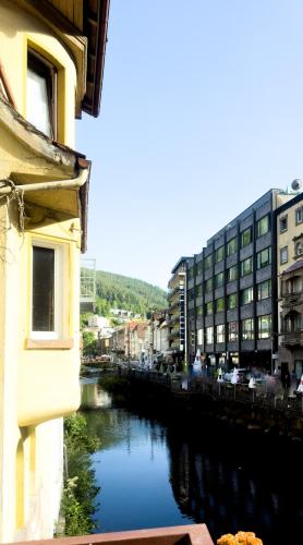 a view of a river in a city with buildings at Vinami-Sonne Hotel in Bad Wildbad