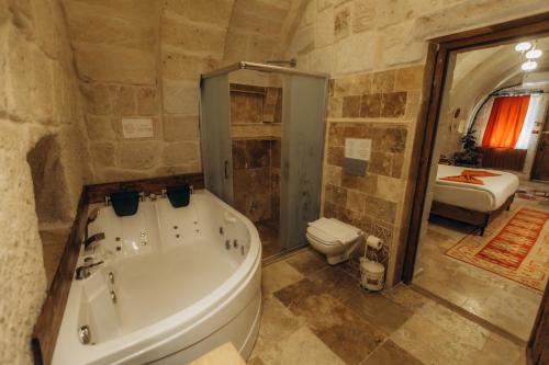 a bathroom with a tub and a toilet and a sink at Timur inn Cappadocia in Goreme