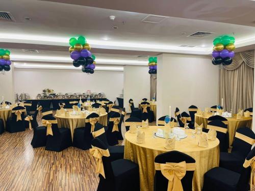 a banquet hall with tables and chairs and balloons at Best Western Plus Mahboula in Kuwait