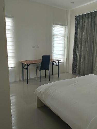 a bedroom with a desk and a chair and a bed at Baan Didi2 in Bophut 