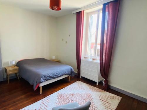 a bedroom with a bed and a window at Grande maison centre ville in Laval