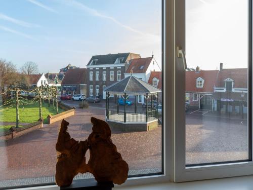 two stuffed animals are looking out of a window at Lovely, modern, 4-person apartment in the heart of Koudekerke in Koudekerke