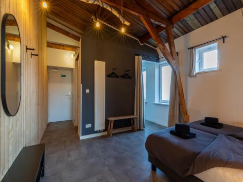a bedroom with a bed and a mirror in a room at Lovely, modern, 4-person apartment in the heart of Koudekerke in Koudekerke
