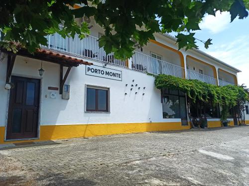 a building with a sign on the side of it at Porto Monte in Maceira