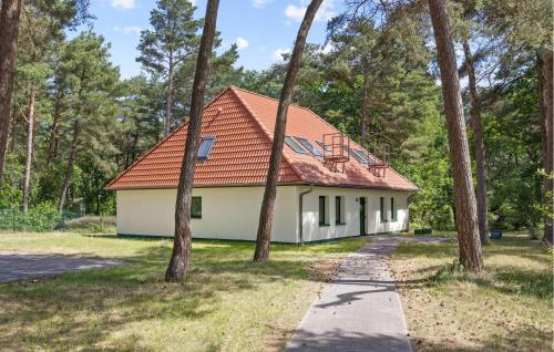 a house with an orange roof in the woods at 3 Bedroom Beautiful Apartment In Altenkirchen in Altenkirchen