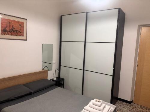 a bedroom with a bed and a large closet at La Spezia stazione centrale - via dei colli in La Spezia