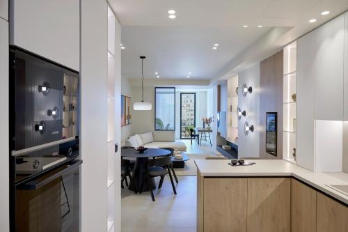 a kitchen and living room with a table and a couch at Fasma Suites Luxury Apartments in Piraeus in Piraeus