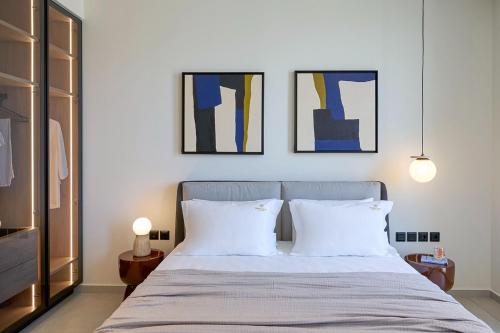 a bedroom with a bed with two white pillows at Fasma Suites Luxury Apartments in Piraeus in Piraeus