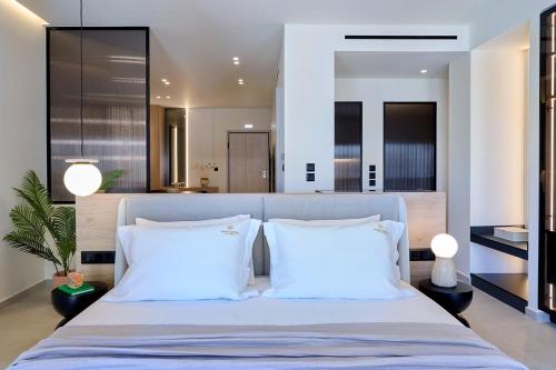 a bedroom with a large bed with two white pillows at Fasma Suites Luxury Apartments in Piraeus in Piraeus