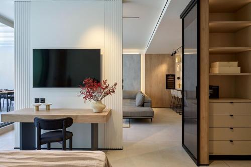 a living room with a table and a couch at Fasma Suites Luxury Apartments in Piraeus in Piraeus