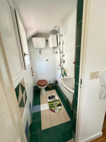 a bathroom with a toilet and a sink at Florence Sweet Nest in Florence