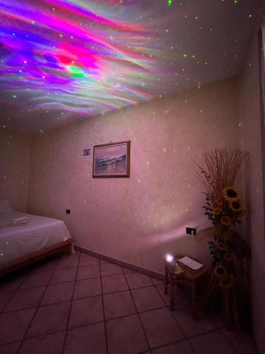 a room with a ceiling with colorful lights on it at Green House in Somma Lombardo