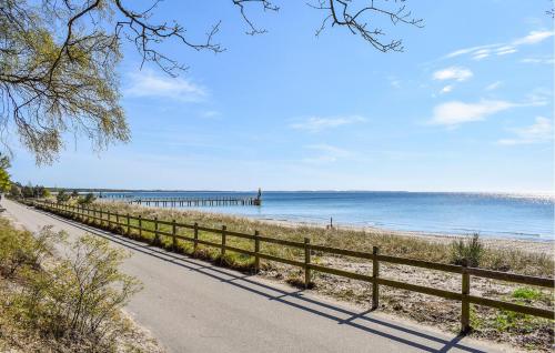 a road next to the beach with a pier at Lovely Apartment In Ystad With Wifi in Ystad