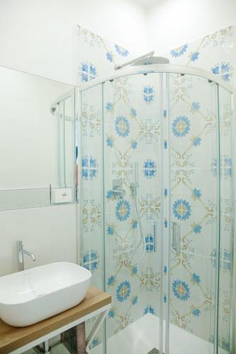 a bathroom with a shower and a sink at Dimora Luminè in Naples