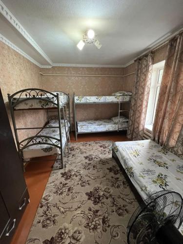 a room with two bunk beds and a rug at Lovely home shatry in Osh