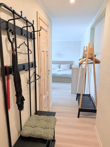 a room with a treadmill and a room with a bed at Jūras 3 street apartment in Liepāja