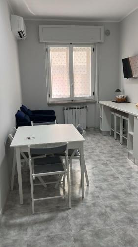 a dining room with a white table and chairs at Annarè Home in Vasto