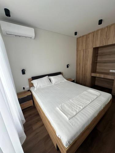a bedroom with a large bed with white sheets at Апартаменти La Familia в ЖК Республіка Rs113 in Kyiv