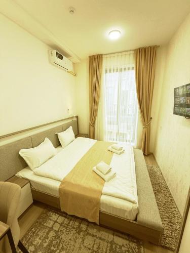 a hotel room with a bed and a window at SADI Hotel in Yakkasaray